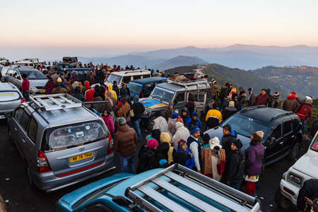 People and cars are seeing the first light of new year's day at dawn with mountain villages and Kangchenjunga mountain in winter at Tiger Hill, Darjeeling. India.のeditorial素材