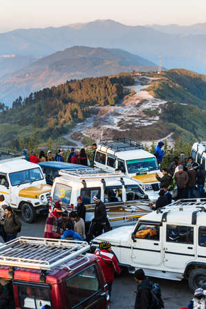Cars and tourists are wearing coat with mountain and trees in background in the morning at The Tiger...