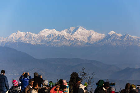 People are seeing the first light of new year's day at dawn with mountain villages and Kangchenjunga mountain in winter at Tiger Hill, Darjeeling. India.のeditorial素材