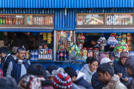 Tourists in front of blue grocery store in the market near Tiger Hill in winter at Darjeeling,...