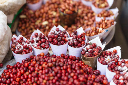 Red Berries topping with salt in paper cone at street local market in Darjeeling. India.の写真素材