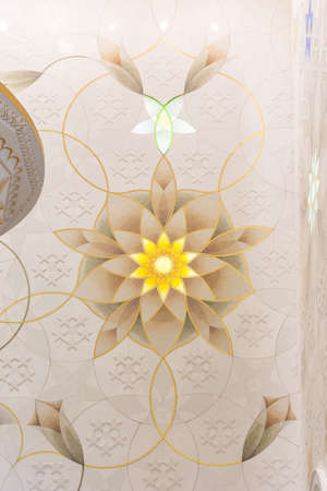 Wall decorated with golden geometric form in Sheikh Zayed Grand Mosque with blue sky in the morning at Abu Dhabi, UAE.のeditorial素材