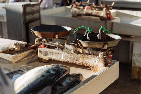 Fish scales of fishmonger cut fish for sell at semi-outdoor, open air seafood market near Palm Deira metro station in Dubai.の写真素材