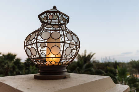 Lighted outdoor lamp decorated with Arabic circle pattern at hotel bar in Dubai.の写真素材