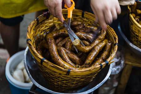 Sai Ua contains minced pork meat, herbs, spices, and Kaeng Khua red curry paste. It is usually eaten grilled with sticky rice and other dishes or served as a snack or starter.の写真素材