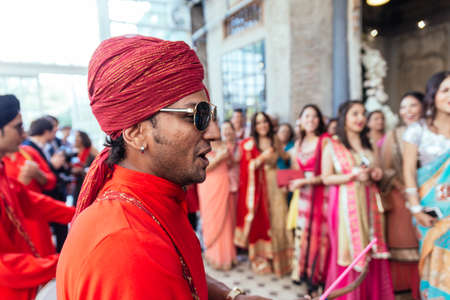 Musician band wearing red Bandhgala and Pheta at Indian wedding ceremony in Bangkok, Thailand.のeditorial素材