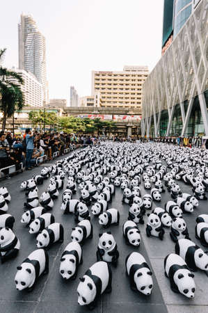 Many panda sculptures place on the floor is an art exhibition with audiences and visitors take photos in Bangkok, Thailand.のeditorial素材