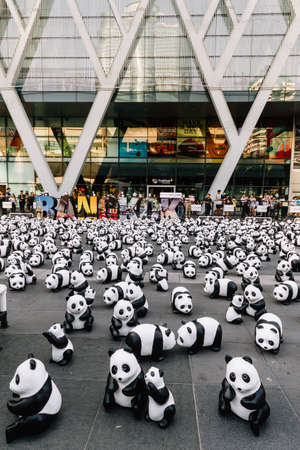 Many panda sculptures place on the floor is an art exhibition with audiences and visitors take photos in Bangkok, Thailand.のeditorial素材