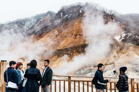 Tourists with Noboribetsu Jigokudani (Hell Valley): The volcano valley got its name from the sulfuric smell in Hokkaido, Japan.のeditorial素材