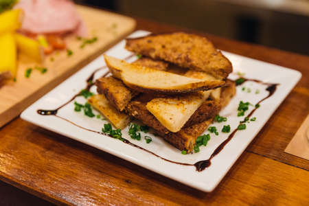Cut toasts with mince scallion, rosemary and balsamic dressing.の写真素材