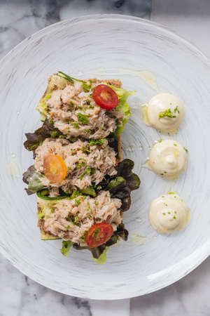 Crab bruschetta with sliced zucchini, red oak and tomato with olive oil. Served with mayonnaise.の写真素材