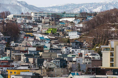 Cityscape with snow mountain in the background in winter in Hokkaido, Japan.のeditorial素材