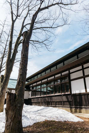 The Hokkaido Shrine (Hokkaido Jingu) with leafless tree and pile of snow in winter in Sapporo....