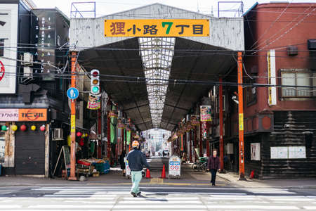 People waking on the street that along with buildings and roof in Sapporo at Hokkaido, Japan.のeditorial素材