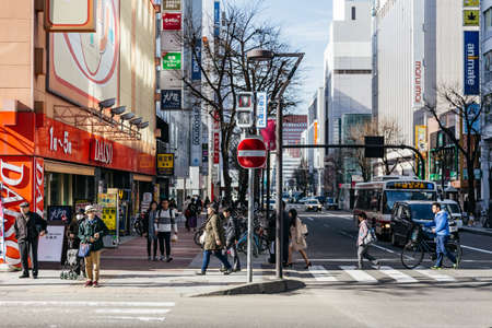 Sapporo cityscape with buildings, road, cars and walking people in Hokkaido, Japan.のeditorial素材