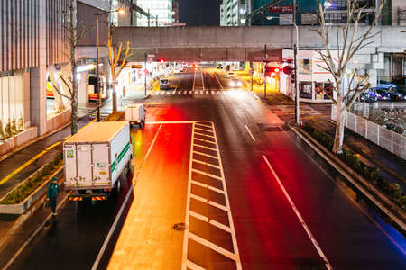 Empty Sapporo street with orange and red lights reflection in the night at Hokkaido, Japan.のeditorial素材