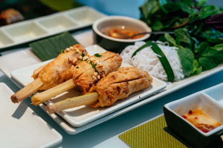 Vietnamese Meatball Wraps (Nam Neung) served with vegetables, rice noodles and sauce at the...