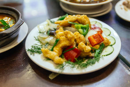 Fried fish stired with onion, mushroom and bell pepper at the restaurant in Hanoi, Vietnam.の写真素材