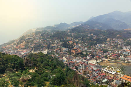 Sa Pa landscape with city, mountains, fog and trees the view from above from Sam Bay Cloud Yard in summer at Ham Rong Mountain Park in Sa Pa, Vietnam.のeditorial素材