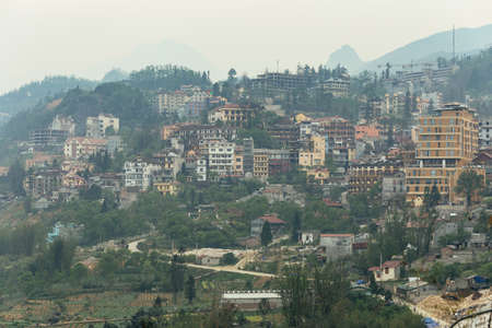 Cityscape on the mountain with fog and trees in summer in the dusk in Sa Pa, Vietnam.の写真素材