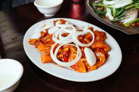 Marinated fresh salmon with sliced onion ready for grill at the restaurant in Sa Pa, Vietnam.の写真素材