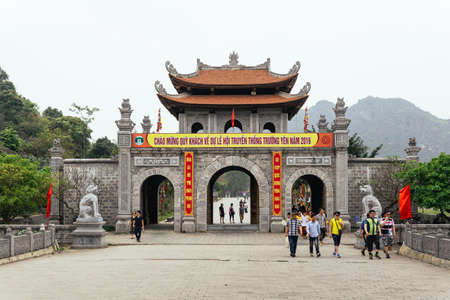 Chinese style entrance gate with tourists near Trang An Landscape Complex in summer in Ninh Binh, Vietnam.のeditorial素材