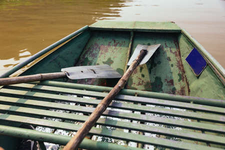 Close up paddles that made by wood and steel in rowing boat at Trang An Grottoes in Ninh Binh,...