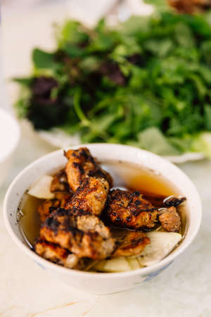 Buncha is a Vietnamese dish of grilled pork and noodle served with vegetables at the restaurant in...