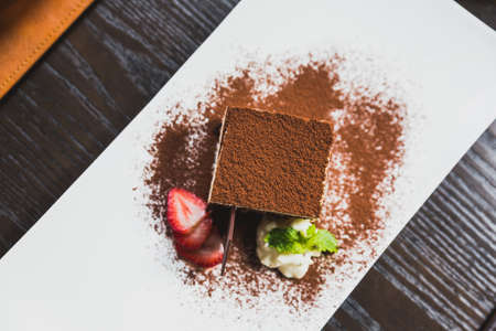 Tiramisu is a popular coffee-flavoured Italian dessert. It is made of ladyfingers dipped in coffee, layered with a whipped mixture of eggs, sugar, and mascarpone cheese, flavoured with cocoa.の写真素材