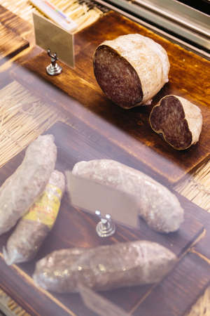 Saucisson is a variety of thick, dry cured sausage that originates in France. Typically made of pork, or a mixture of pork and other meatsの写真素材