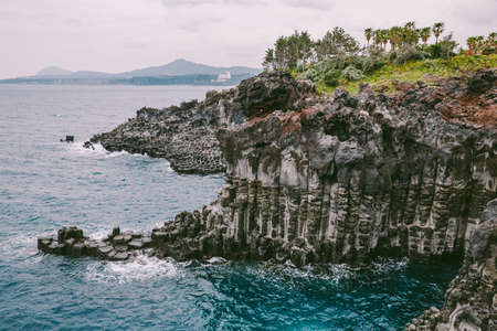 Volcanic Rock Shore at Jusangjeolli. Jeju Island, South Korea. The Jusangjeolli (columnar jointing) cliff is a spectacular volcanic rock formation at the southern coast of Jeju Island.の写真素材