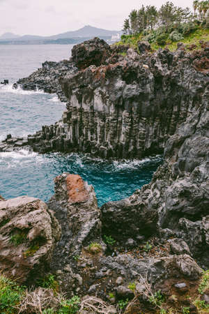 Volcanic Rock Shore at Jusangjeolli. Jeju Island, South Korea. The Jusangjeolli (columnar jointing) cliff is a spectacular volcanic rock formation at the southern coast of Jeju Island.の写真素材