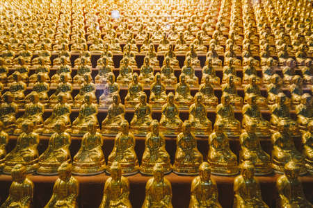 Small golden Buddha statues inside Yakcheonsa Temple. Jeju, South Korea.