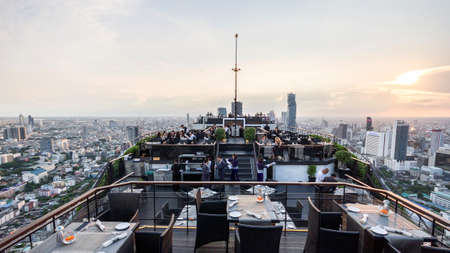 Rooftop dinning area with cityscape and at the dusk. With city and traffic lights.のeditorial素材