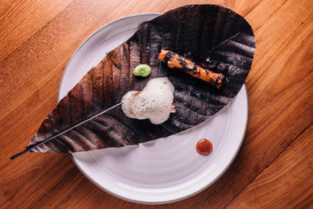 Creative Fine Dining: Fish topping with culinary foam serves with pea and grilled root with salt on...