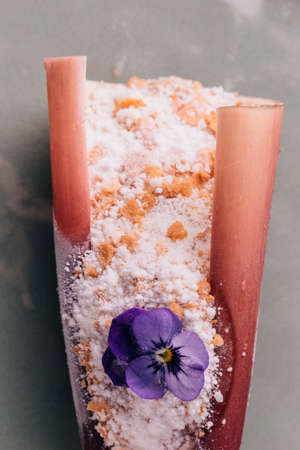 Creative Fine Dining Dessert: Touched banana topping with toffee cook by liquid nitrogen, looks like snow. Served in banana blossom peel and decorated with flower.の写真素材