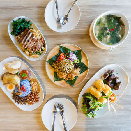 Asian meal dishes including Laphet, Nasi Lemak, Drunken Noodles with grilled pork, Grilled sticky rice with egg and Hot and Spicy Soup with Pork Rib.の写真素材