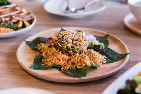 Lahpet is Burmese Tea Leaf Salad served with deep fried garlic, peanut, white sesame, dried shrimp, ginger and roasted coconut.の写真素材