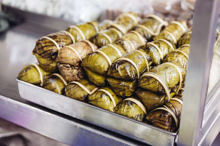 Khao tom mat is a Laotian and Thai dessert of seasoned steamed sticky rice wrapped in banana leaves.