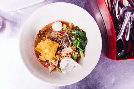 Top view of Yen Ta Fo, Noodles with seafood soup and red sauce.の写真素材