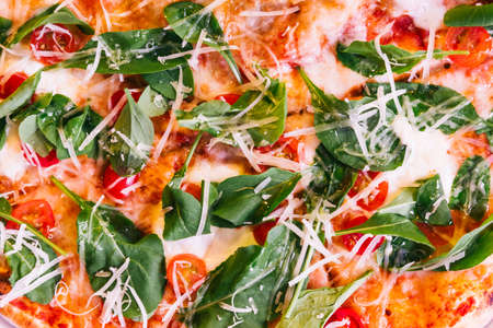 Closeup texture of Neapolitan Pizza made with tomatoes, basil and mozzarella cheese.の写真素材