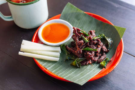 Neur Dad Diew (Thai Fried Sun-Dried Beef) with chili sauce served with iced passion fruit juice.の写真素材