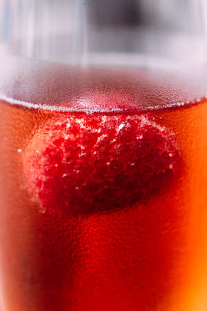 Close up Red cocktail with raspberry inside in glass wine.の写真素材