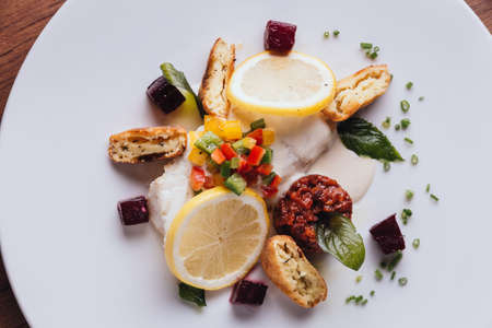 Cod fish fillet pan baked in lemon with cos, beet root, string bean, potato and champagne white wine...