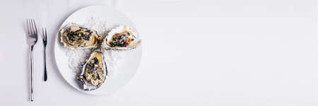 Oyster Rockefeller and sake-poached oyster, cooked in hijki butter and black seaweed.  With copy...