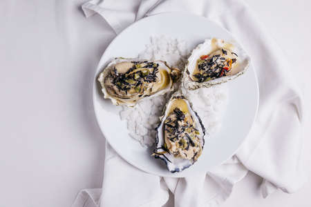 Oyster Rockefeller and sake-poached oyster, cooked in hijki butter and black seaweed.