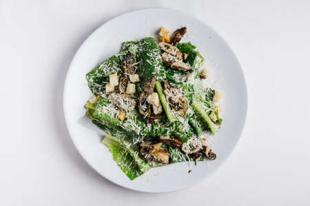 Oysters Caesar salad served in white plate over white tablecloth.の写真素材
