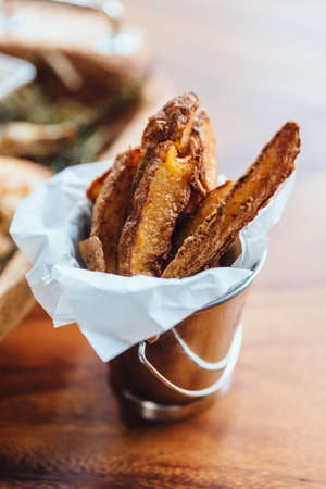 Peeled potato fries served in silver bucket as an appetizer or side dish.の写真素材