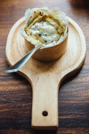Top view of Brie cheese on wooden board on wooden tableの写真素材