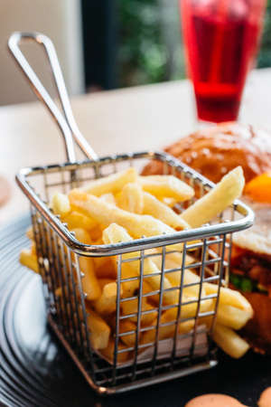 French Fries served in steel basket for eating with burger.の写真素材